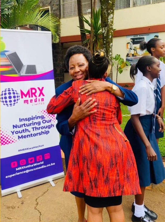 A student embraces Mwalimu Rachel at an MRX Kwa Machuo school visit